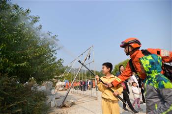 Campaign to publicize wildfire suppression launched to mark Int'l Day for Disaster Reduction