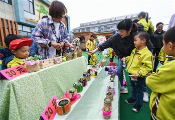Campus charity bazaar held in Changxing County, E China's Zhejiang