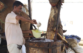 Sesame oil sellers work at oil mill in Hajjah Province, Yemen
