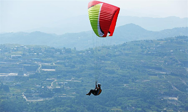 Tourists experience paragliding at Gujian Mountain scenic area in SW China's Chongqing