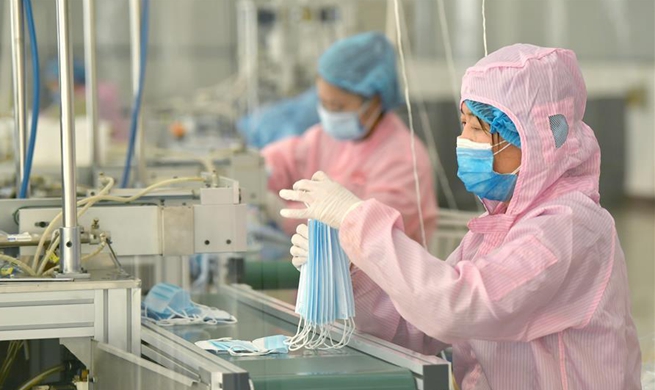 Workers make protective equipment to help fight novel coronavirus