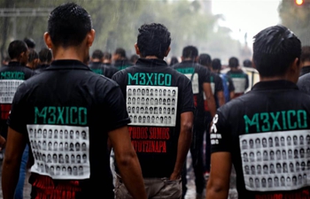 People take part in commemorative march in Mexico City