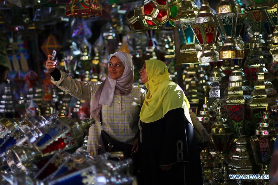 Egyptian people are seen at a Ramadan lantern shop in Cairo, Egypt on May 28, 2016. 