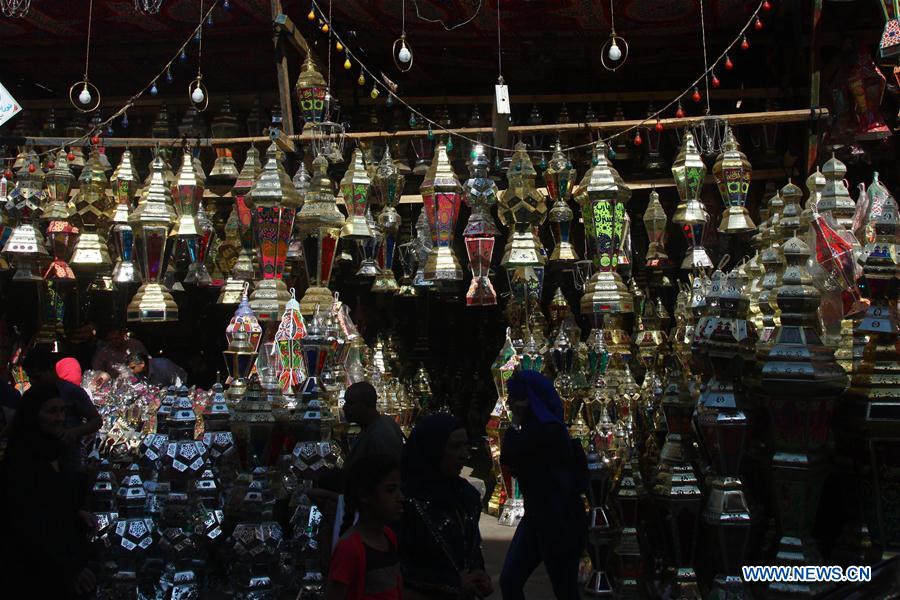 Egyptian people are seen at a Ramadan lantern shop in Cairo, Egypt on May 28, 2016. 
