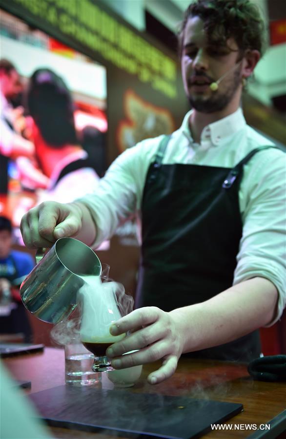 A barista makes fancy coffee during the 5th Fushan Cup International Barista Championship of China in Chengmai, south China's Hainan Province, June 6, 2016