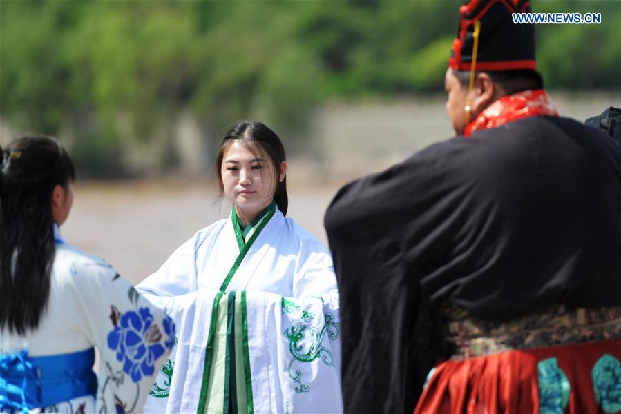 People in Han dresses attend a sacrificial ceremony for Qu Yuan, a patriotic poet who drowned himself before his state fell to the invasion of the enemy during the Warring States Period (475-221 BC), in Lanzhou, capital of northwest China's Gansu Province, June 9, 2016. People in Han dresses attend a sacrificial ceremony for Qu Yuan, a patriotic poet who drowned himself before his state fell to the invasion of the enemy during the Warring States Period (475-221 BC), in Lanzhou, capital of northwest China's Gansu Province, June 9, 2016.