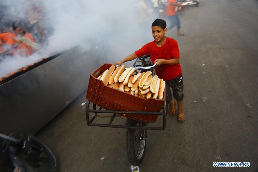 Egyptian people gather to have a fast-breaking Iftar meal during the holy month of Ramadan at old Cairo, Egypt, on June 9, 2016. 