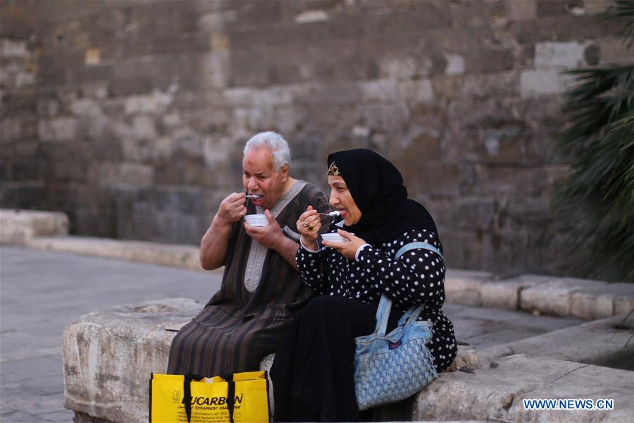 Egyptian people gather to have a fast-breaking Iftar meal during the holy month of Ramadan at old Cairo, Egypt, on June 9, 2016. 
