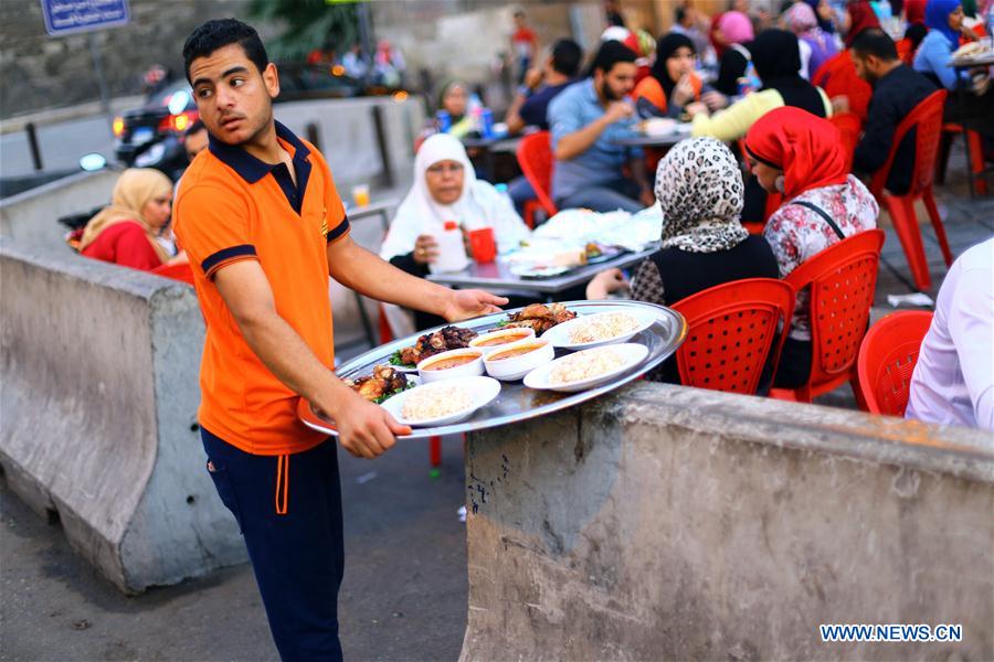 Egyptian people gather to have a fast-breaking Iftar meal during the holy month of Ramadan at old Cairo, Egypt, on June 9, 2016. Egyptian people gather to have a fast-breaking Iftar meal during the holy month of Ramadan at old Cairo, Egypt, on June 9, 2016.