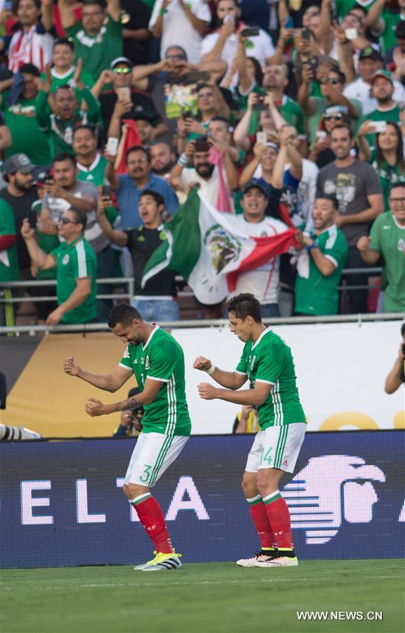 Jamaica's Clayton Donaldson (Top) is tackled during the Copa America Centenario tournament Group C football match between Mexico and Jamaica in Pasadena, California, the United States, on June 9, 2016.