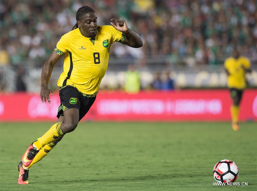 Jamaica's Clayton Donaldson (Top) is tackled during the Copa America Centenario tournament Group C football match between Mexico and Jamaica in Pasadena, California, the United States, on June 9, 2016. Jamaica's Clayton Donaldson (Top) is tackled during the Copa America Centenario tournament Group C football match between Mexico and Jamaica in Pasadena, California, the United States, on June 9, 2016.