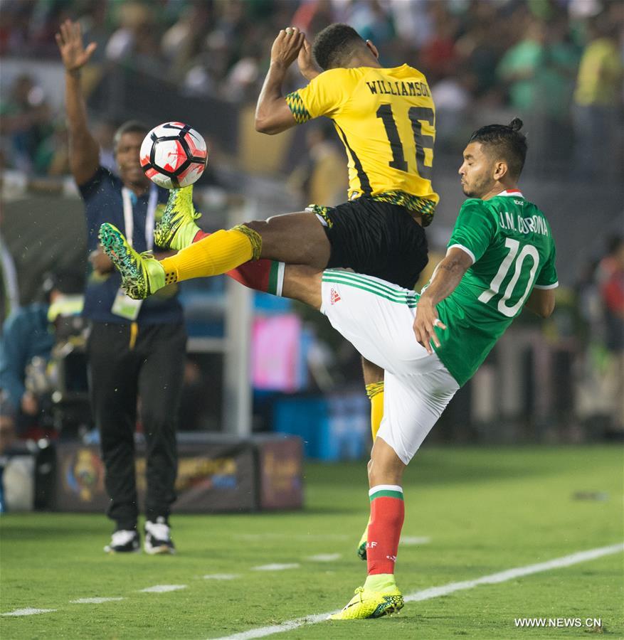 Jamaica's Clayton Donaldson (Top) is tackled during the Copa America Centenario tournament Group C football match between Mexico and Jamaica in Pasadena, California, the United States, on June 9, 2016. Jamaica's Clayton Donaldson (Top) is tackled during the Copa America Centenario tournament Group C football match between Mexico and Jamaica in Pasadena, California, the United States, on June 9, 2016.