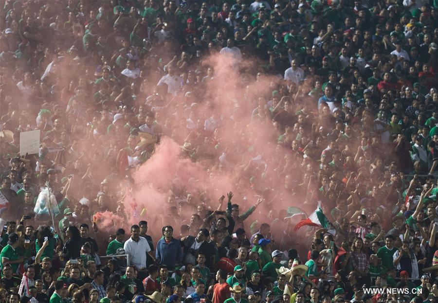 Jamaica's Clayton Donaldson (Top) is tackled during the Copa America Centenario tournament Group C football match between Mexico and Jamaica in Pasadena, California, the United States, on June 9, 2016. Jamaica's Clayton Donaldson (Top) is tackled during the Copa America Centenario tournament Group C football match between Mexico and Jamaica in Pasadena, California, the United States, on June 9, 2016.