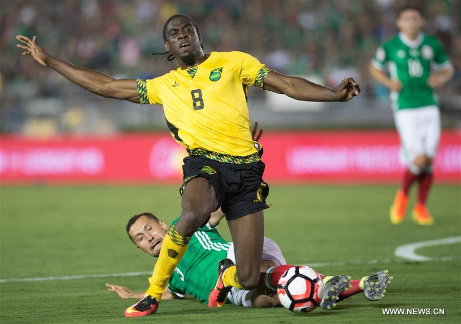 Jamaica's Clayton Donaldson (Top) is tackled during the Copa America Centenario tournament Group C football match between Mexico and Jamaica in Pasadena, California, the United States, on June 9, 2016.