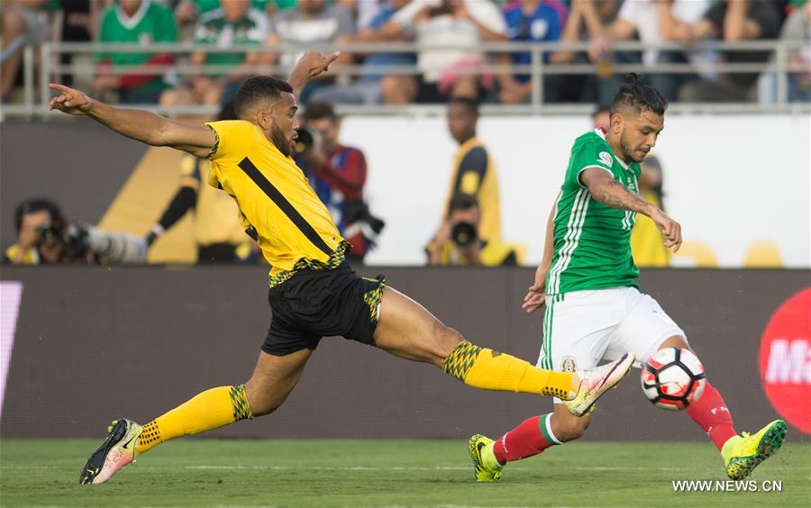 Mexico's Jesus Manuel Corona (R) passes the ball as Jamaica's Giles Barnes tries to stop him during the Copa America Centenario tournament Group C football match in Pasadena, California, the United States, on June 9, 2016 Mexico's Jesus Manuel Corona (R) passes the ball as Jamaica's Giles Barnes tries to stop him during the Copa America Centenario tournament Group C football match in Pasadena, California, the United States, on June 9, 2016
