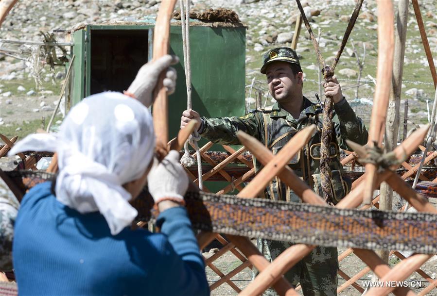 Frontier guards helped Kirgiz nomads move to their summer pasture over the border areas of some 4,000 meters above the sea level here in Xinjiang