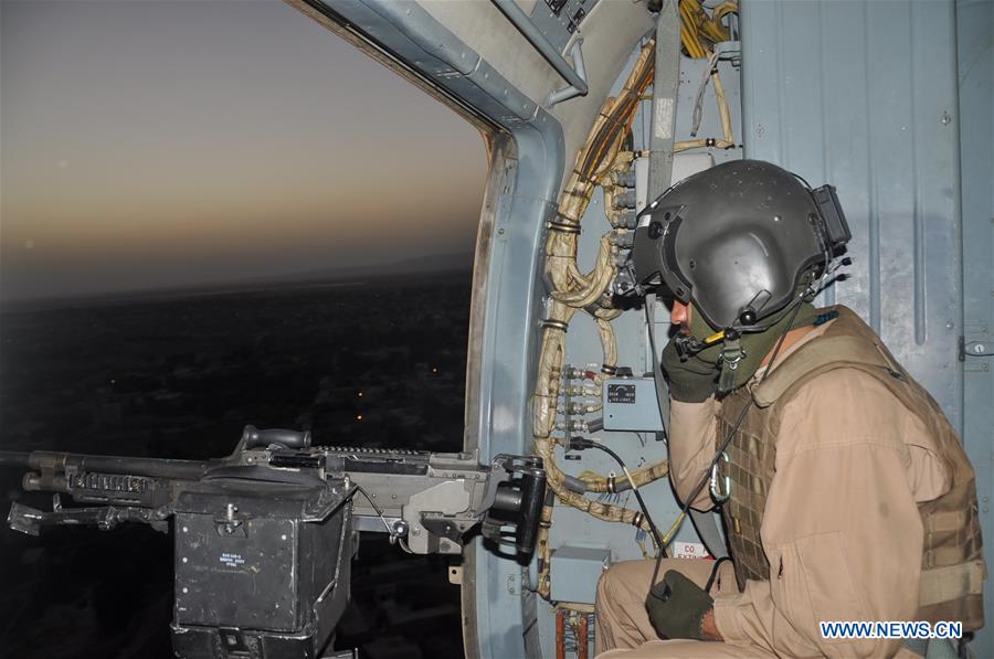 Afghan security force members sit on a vehicle during a military operation in Jawzjan province, Afghanistan, on June 12, 2016.