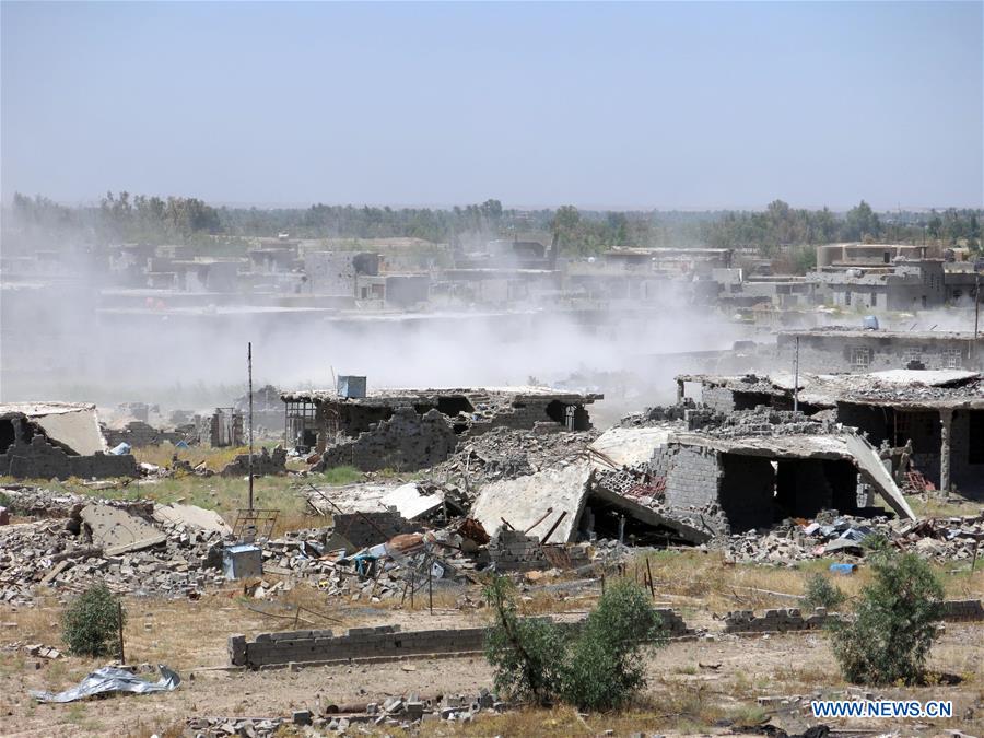 A group of Iraqi army are seen in southern Shuhada district, south Fallujah city in Iraq's western Anbar province, in battles against Islamic State (IS), on June 13, 2016.