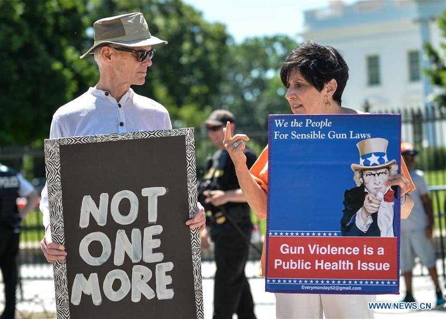 People attend a rally calling for legislation on gun violence prevention and gun control outside the White House, in Washington D.C., capital of the United States, June 13, 2016.