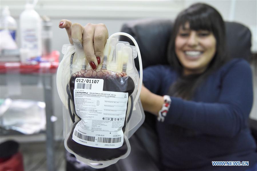 Photo taken on June 9, 2016 shows Lilian Garcia, a hemotherapy technician, doing tests on donor blood samples in Montevideo, capital of Uruguay Photo taken on June 9, 2016 shows Lilian Garcia, a hemotherapy technician, doing tests on donor blood samples in Montevideo, capital of Uruguay