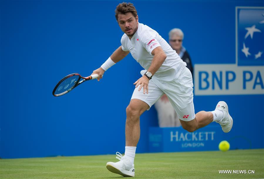 Stan Wawrinka of Switzerland returns a shot during his singles first round match against Fernando Verdasco of Spain during day two of the ATP-500 Aegon Championships at the Queen's Club in London, Britain on June 14, 2016