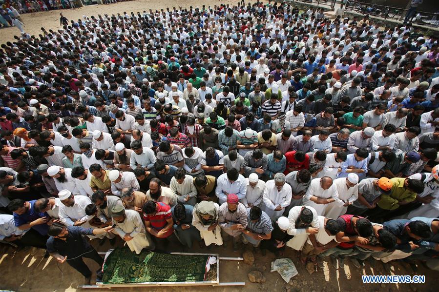 People cry during the funeral of Tanvir Ahmad Sheikh in Srinagar, summer capital of Indian-controlled Kashmir, on June 15, 2016. 