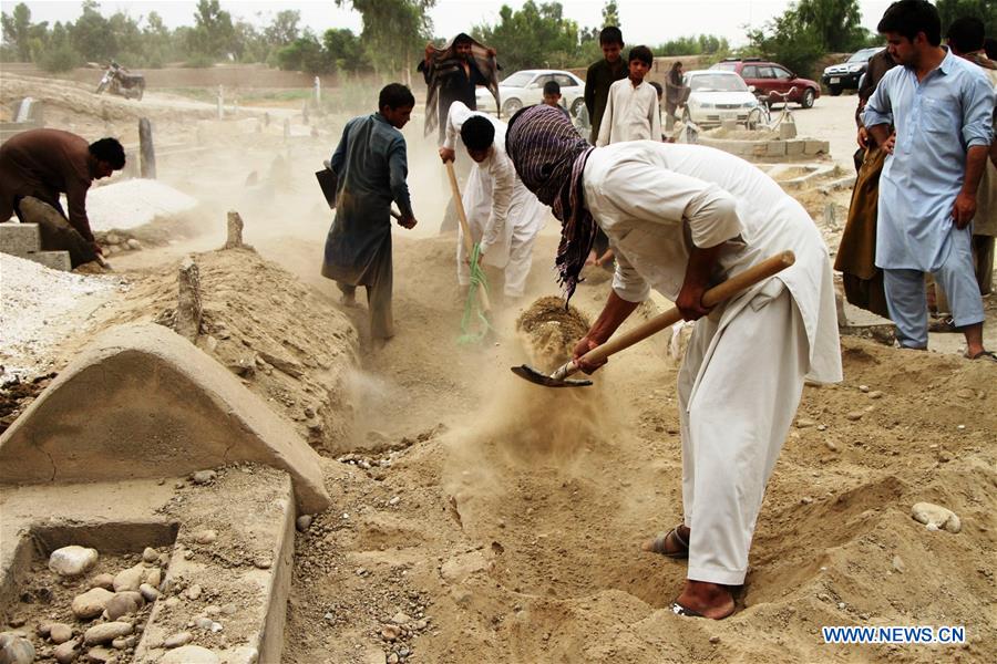 Relatives attend the funeral of a border policeman in Jalalabad, capital of eastern Nangarhar province, Afghanistan, on June 15, 2016.