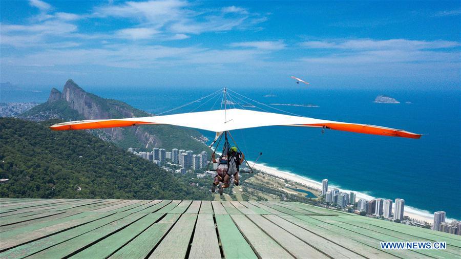 This file photo shows gliding enthusiasts flying with a delta wing from a platform located at the Pedra Bonita of Mountain Gavea in Rio de Janeiro, Brazil on Feb. 10, 2015. 
