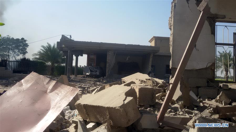 A man stands by a destroyed building after an airstrike by the Iraqi Air Force in southern Fallujah, 50 kilometers west of Baghdad, Iraq, on June 15, 2016.
