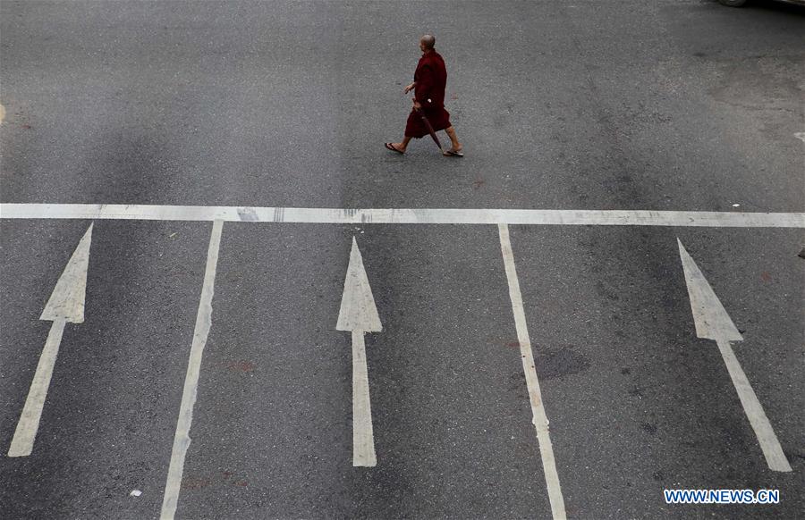 A labor carries bricks at a jetty on the outskirts of Yangon, Myanmar, June 16, 2016.