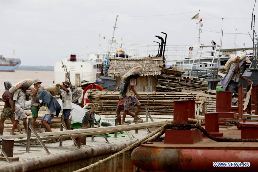 A labor carries bricks at a jetty on the outskirts of Yangon, Myanmar, June 16, 2016. A labor carries bricks at a jetty on the outskirts of Yangon, Myanmar, June 16, 2016.