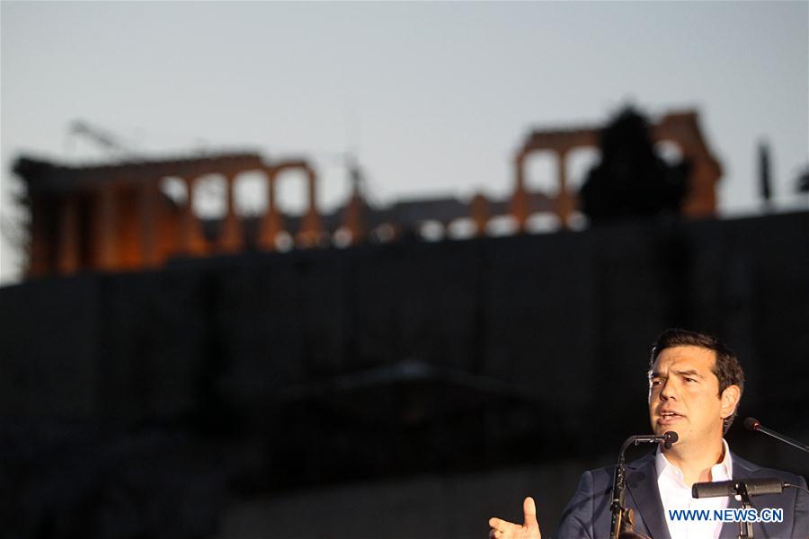 Greek Prime Minister Alexis Tsipras delivers a speech at the Acropolis museum with the ancient Parthenon temple seen in the background in Athens, Greece, June 16, 2016. 