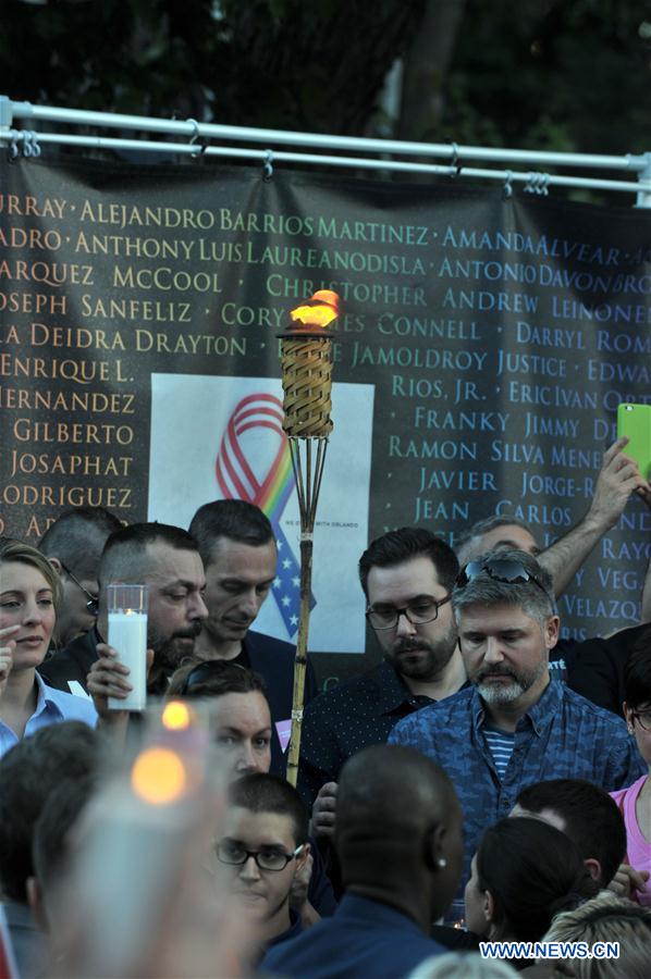 People hold candles and a torch to pay tribute to Orlando nightclub shooting victims, in downtown Montreal, Canada, on June 16, 2016. People hold candles and a torch to pay tribute to Orlando nightclub shooting victims, in downtown Montreal, Canada, on June 16, 2016.