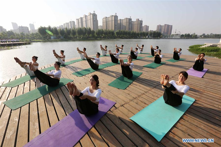People practise yoga at the Longquan Lake Park in Wuzhi County of Jiaozuo, central China's Henan Province, June 18, 2016. People practise yoga at the Longquan Lake Park in Wuzhi County of Jiaozuo, central China's Henan Province, June 18, 2016.