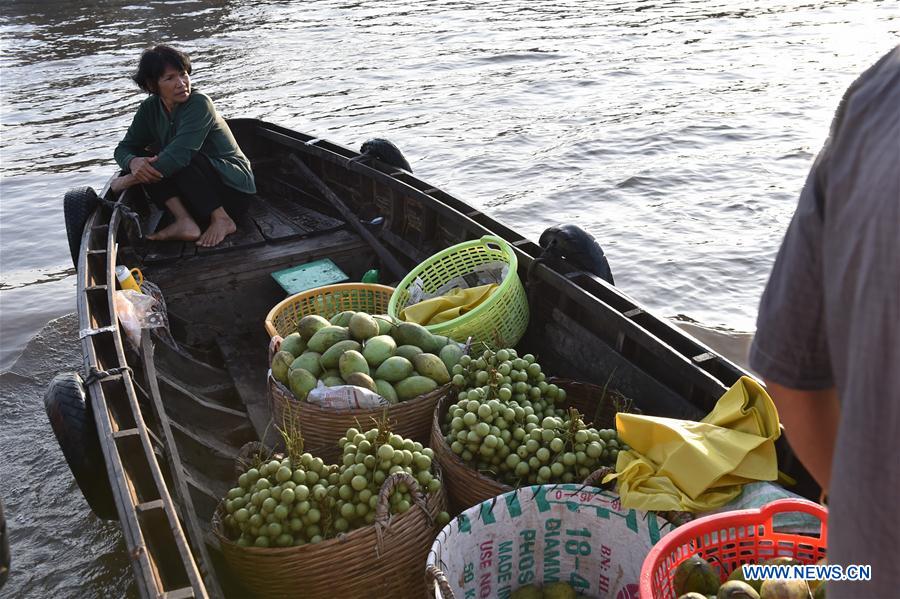 A Vietnamese vendor sells fruits in Can Tho's largest floating market Cai Rang, Vietnam, June 21, 2016