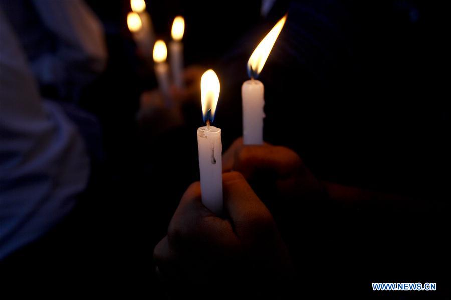 Nepalese people hold candles to memorize victims of a suicide bombing in Afghanistan, in Kathmandu, Nepal, June 23, 2016.