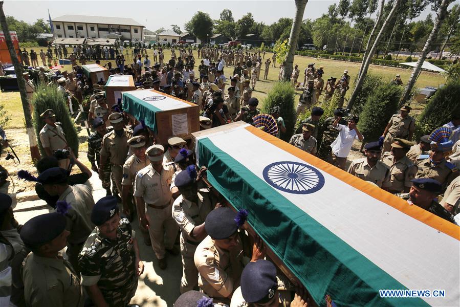 A senior Indian police official salutes to the slain Indian paramilitary troopers during a wreath laying ceremony in Humhama, on the outskirts of Srinagar, summer capital of Indian-controlled Kashmir, June 26, 2016.