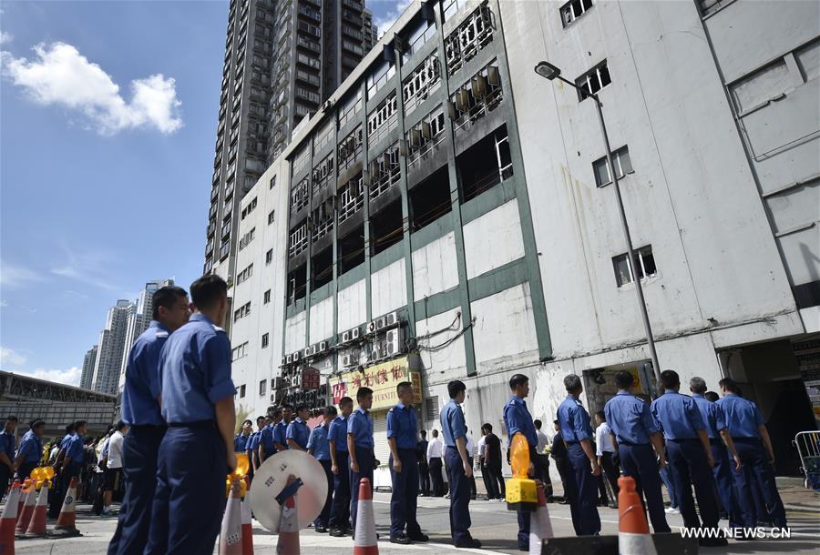 A memorial service is held at the fire site of an industrial building in Hong Kong's East Kowloon to pay tribute to Thomas Cheung, a 30-year-old senior station officer who died while battling the fire, in south China's Hong Kong, June 27, 2016. A memorial service is held at the fire site of an industrial building in Hong Kong's East Kowloon to pay tribute to Thomas Cheung, a 30-year-old senior station officer who died while battling the fire, in south China's Hong Kong, June 27, 2016.