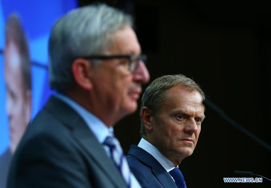 European Council President Donald Tusk (C) and European Commission President Jean-Claude Juncker (L) attend a press conference at the EU headquarters in Brussels, Belgium, June 29, 2016. 