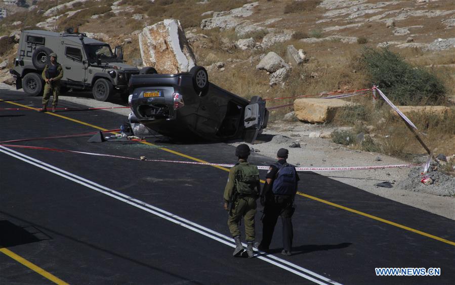 Israeli security forces gather at the scene where an Israeli died and three of his relatives were wounded after a suspected Palestinian gunman opened fire at their car on July 1, 2016 on route 60, near al-Fawar refugee camp, south of Hebron in the West Bank. Israeli security forces gather at the scene where an Israeli died and three of his relatives were wounded after a suspected Palestinian gunman opened fire at their car on July 1, 2016 on route 60, near al-Fawar refugee camp, south of Hebron in the West Bank.