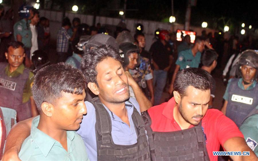 Security personnel stand guard near a restaurant attacked by gunmen in Dhaka, Bangladesh, July 2, 2016. 