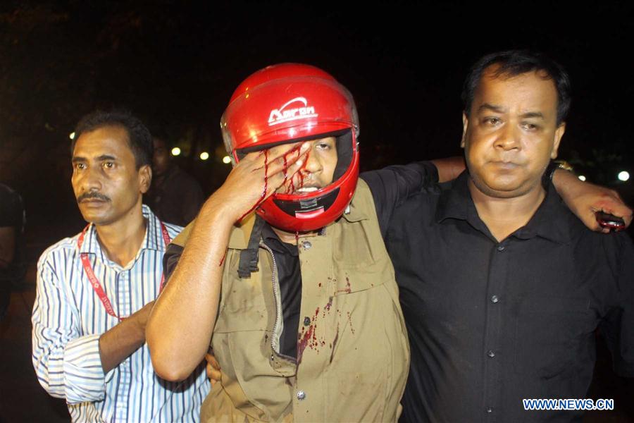 Security personnel stand guard near a restaurant attacked by gunmen in Dhaka, Bangladesh, July 2, 2016. 