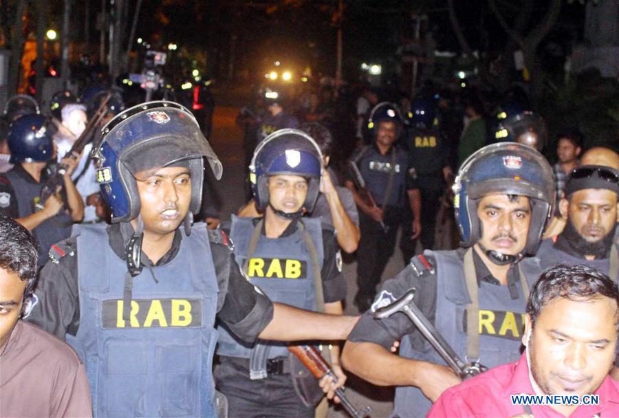 Security personnel stand guard near a restaurant attacked by gunmen in Dhaka, Bangladesh, July 2, 2016. Security personnel stand guard near a restaurant attacked by gunmen in Dhaka, Bangladesh, July 2, 2016.