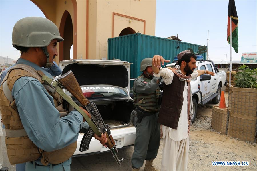 A policeman searches a passenger at a police checkpoint in Ghazni province, eastern Afghanistan, July 4, 2016. A policeman searches a passenger at a police checkpoint in Ghazni province, eastern Afghanistan, July 4, 2016.