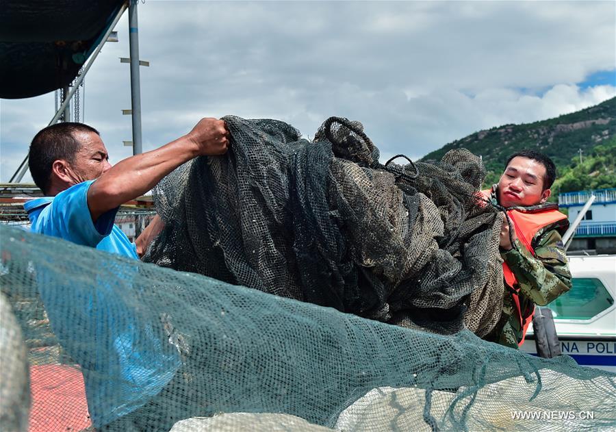 Frontier soldiers help a fisher pull a boat in Nanmenwu Village of Feiluan Township in Jiaocheng District of Ningde, southeast China's Fujian Province, July 7, 2016, before the upcoming Nepartak, the first typhoon of the year. Frontier soldiers help a fisher pull a boat in Nanmenwu Village of Feiluan Township in Jiaocheng District of Ningde, southeast China's Fujian Province, July 7, 2016, before the upcoming Nepartak, the first typhoon of the year.