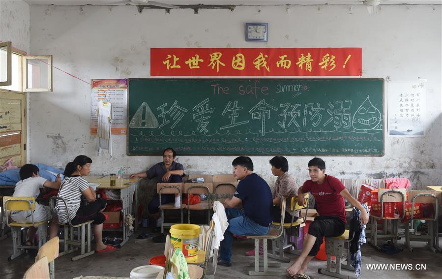 The middle school became a temporary shelter for local people affected by the flood that hit the township recently. The middle school became a temporary shelter for local people affected by the flood that hit the township recently.