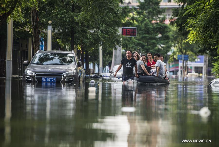 Rescuers push a car out of a flooded street in waterlogged Nanhu Lake area in Wuhan, capital of central China's Hubei Province, July 7, 2016. Rescuers push a car out of a flooded street in waterlogged Nanhu Lake area in Wuhan, capital of central China's Hubei Province, July 7, 2016.