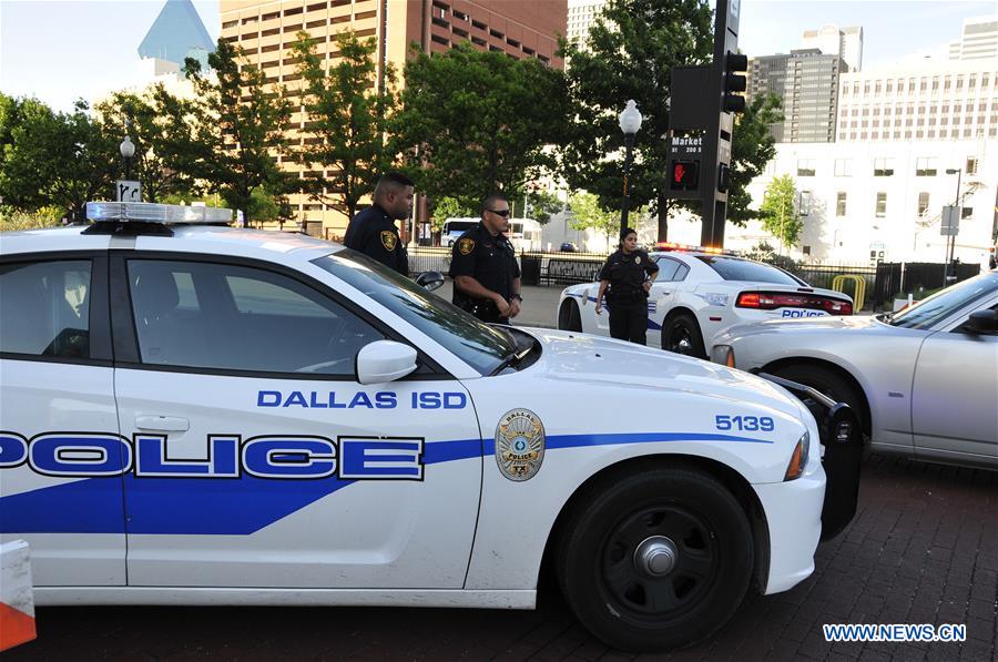An FBI detective works at the scene of shooting of police personnel in Dallas, the United States, July 8, 2016. 