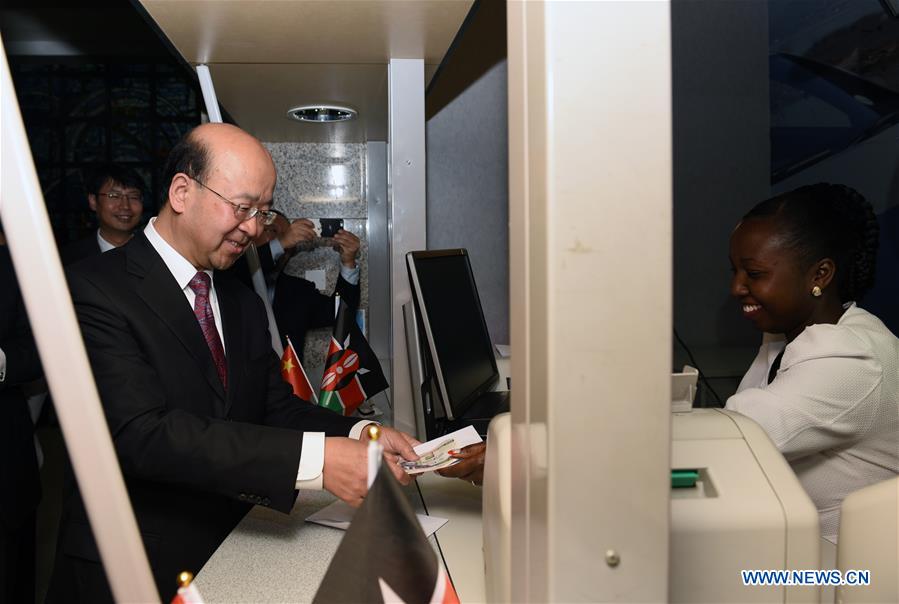 Chinese Ambassador to Kenya Liu Xianfa (L) exchanges Chinese currency RMB into Kenyan Shilling at the headquarter of Kenya's CFC Stanbic Bank in Nairobi, capital of Kenya, July 13, 2016. Chinese Ambassador to Kenya Liu Xianfa (L) exchanges Chinese currency RMB into Kenyan Shilling at the headquarter of Kenya's CFC Stanbic Bank in Nairobi, capital of Kenya, July 13, 2016.