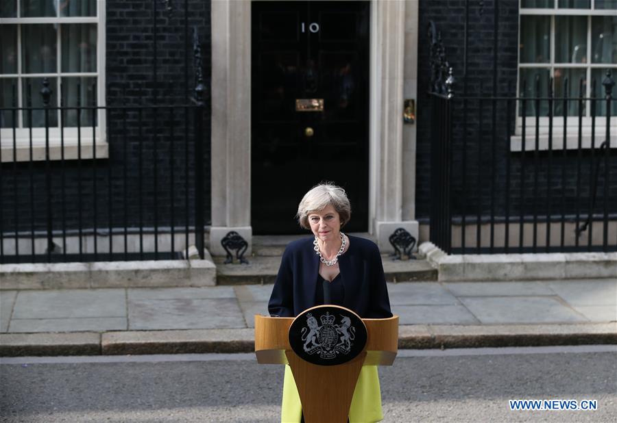 Britain's new Prime Minister Theresa May(L) and her husband pose for photos in front of 10 Downing Street in London, Britain on July 13, 2016. Britain's new Prime Minister Theresa May(L) and her husband pose for photos in front of 10 Downing Street in London, Britain on July 13, 2016.